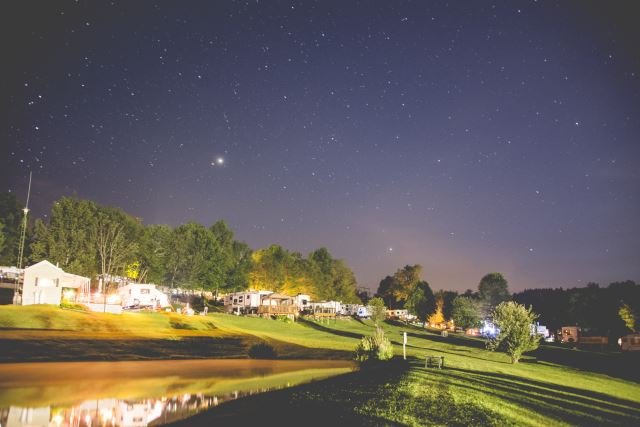 View of camp sites at night at Triple R Campground in Western NY