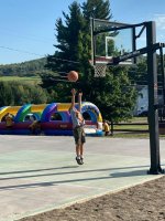 Kids playing basketball on the new basketball court at Triple R