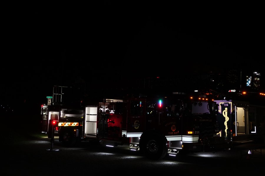 Fire truck lit up at night