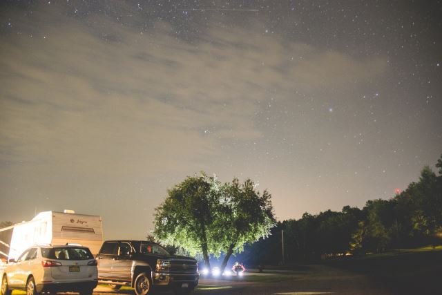 View of camp sites at night at Triple R Campground in Western NY