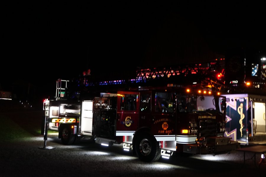 Fire truck lit up at night