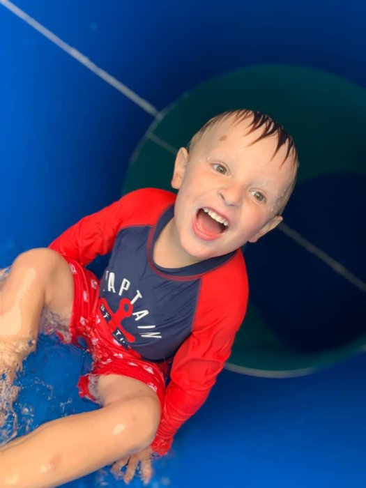 Crazy kid sliding down circular slide in the LeeKee Lagoon at Triple R