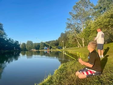 People fishing at the pond at Triple R