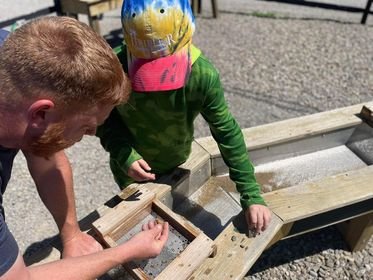 Kid and dad gem mining at Triple R