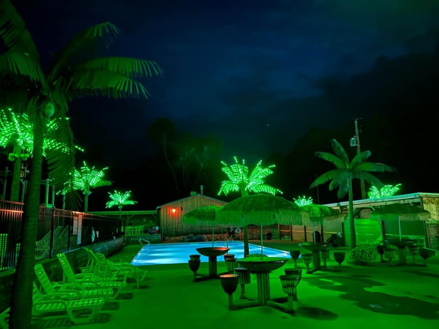 night shot of the pool and hot tub at Triple R