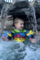 Kids playing under the water fall at Triple R