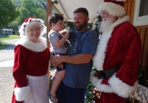 Mr. and Mrs. Claus with campers at the 2019 Christmas in July at Triple R Campground in Western NY